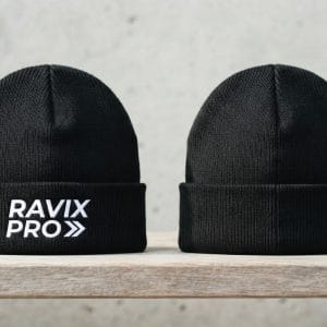 Custom Black Ribbed Beanie with White Embroidered Cuff Logo – front and back view, custom manufactured by Ravix Pro Industry, Sialkot
