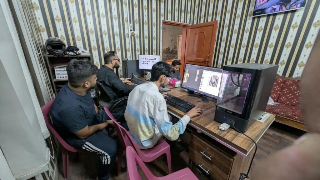 Designer preparing a custom sportswear mock-up on screen at Ravix Pro Industry clothing factory in Daska, Sialkot, Pakistan