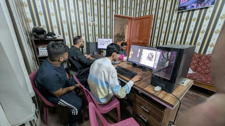 Designer preparing a custom sportswear mock-up on screen at Ravix Pro Industry clothing factory in Daska, Sialkot, Pakistan