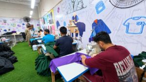 Stitching line sewing sportswear panels at Ravix Pro Industry clothing factory in Daska, Sialkot, Pakistan