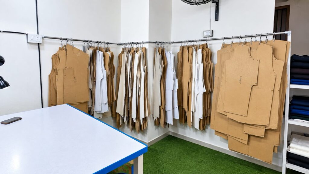Paper patterns and graded sizes on the pattern rack at Ravix Pro Industry clothing factory in Daska, Sialkot, Pakistan