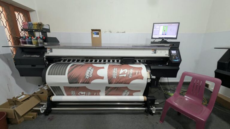 Large-format sublimation printer printing a jersey design at Ravix Pro Industry clothing factory in Daska, Sialkot, Pakistan
