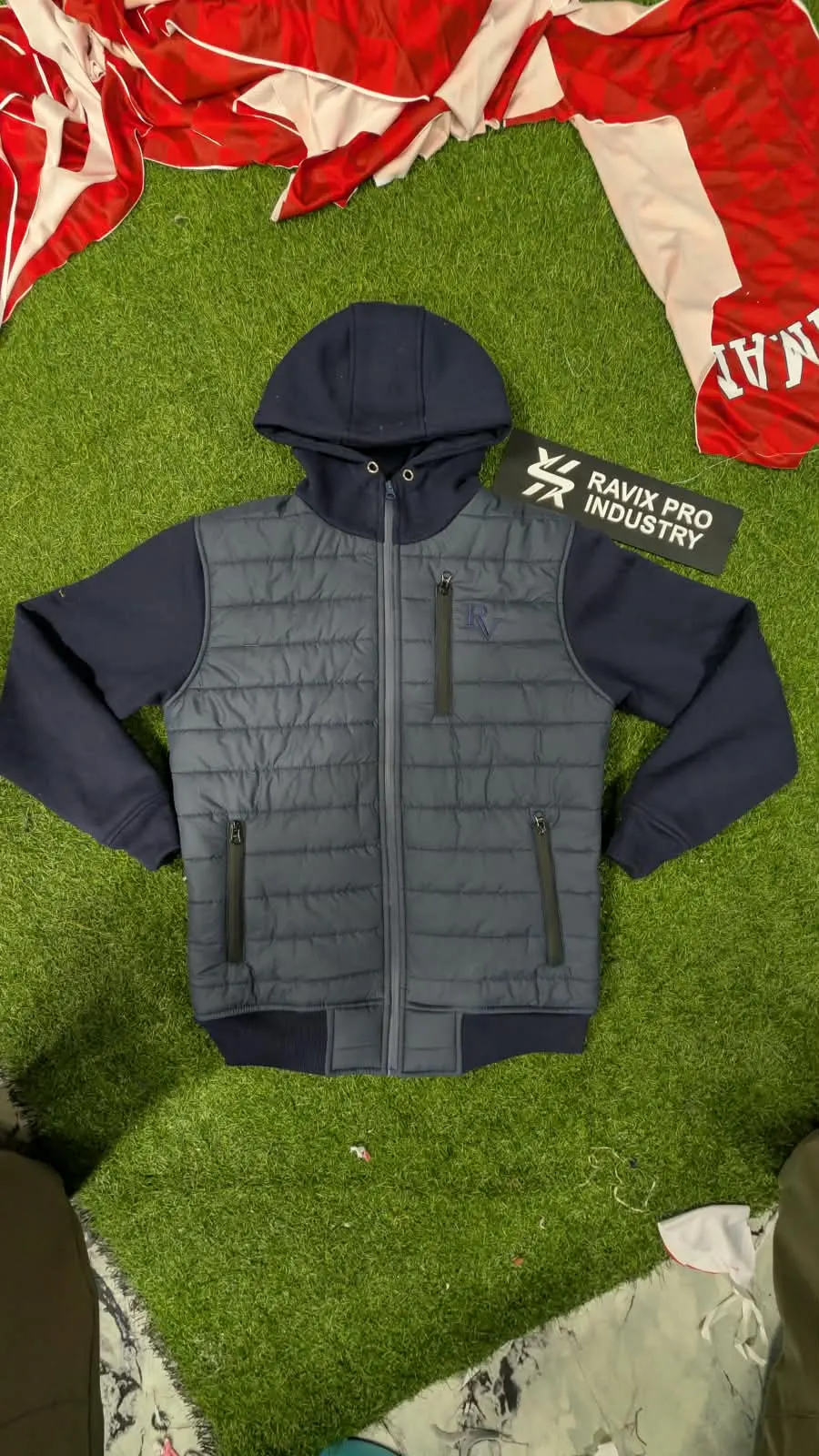 Custom black hybrid puffer jacket with knit hood made by Ravix Pro Industry clothing manufacturer in Sialkot, Pakistan