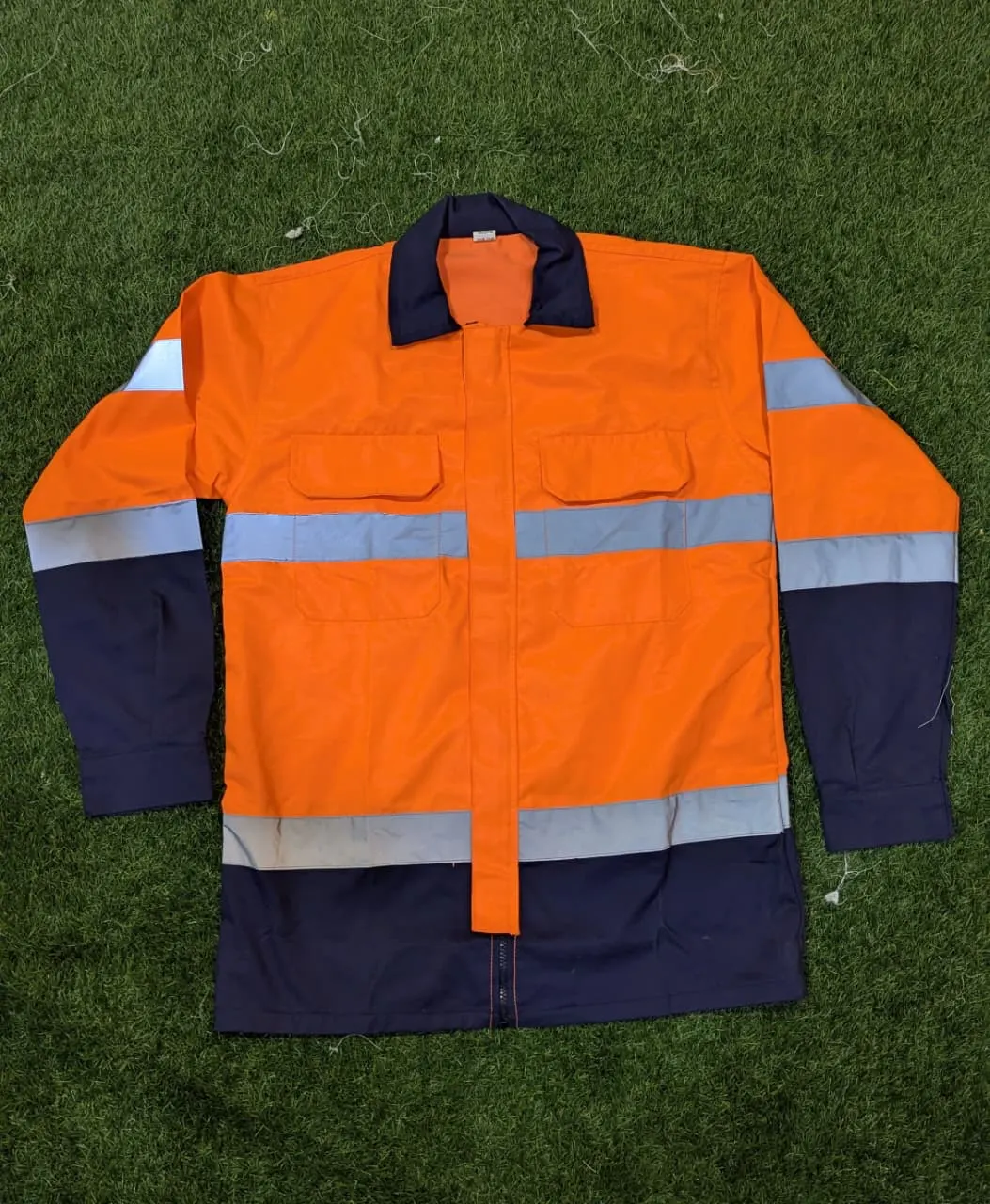 Custom orange and navy hi-vis work shirt made by Ravix Pro Industry clothing manufacturer in Sialkot, Pakistan