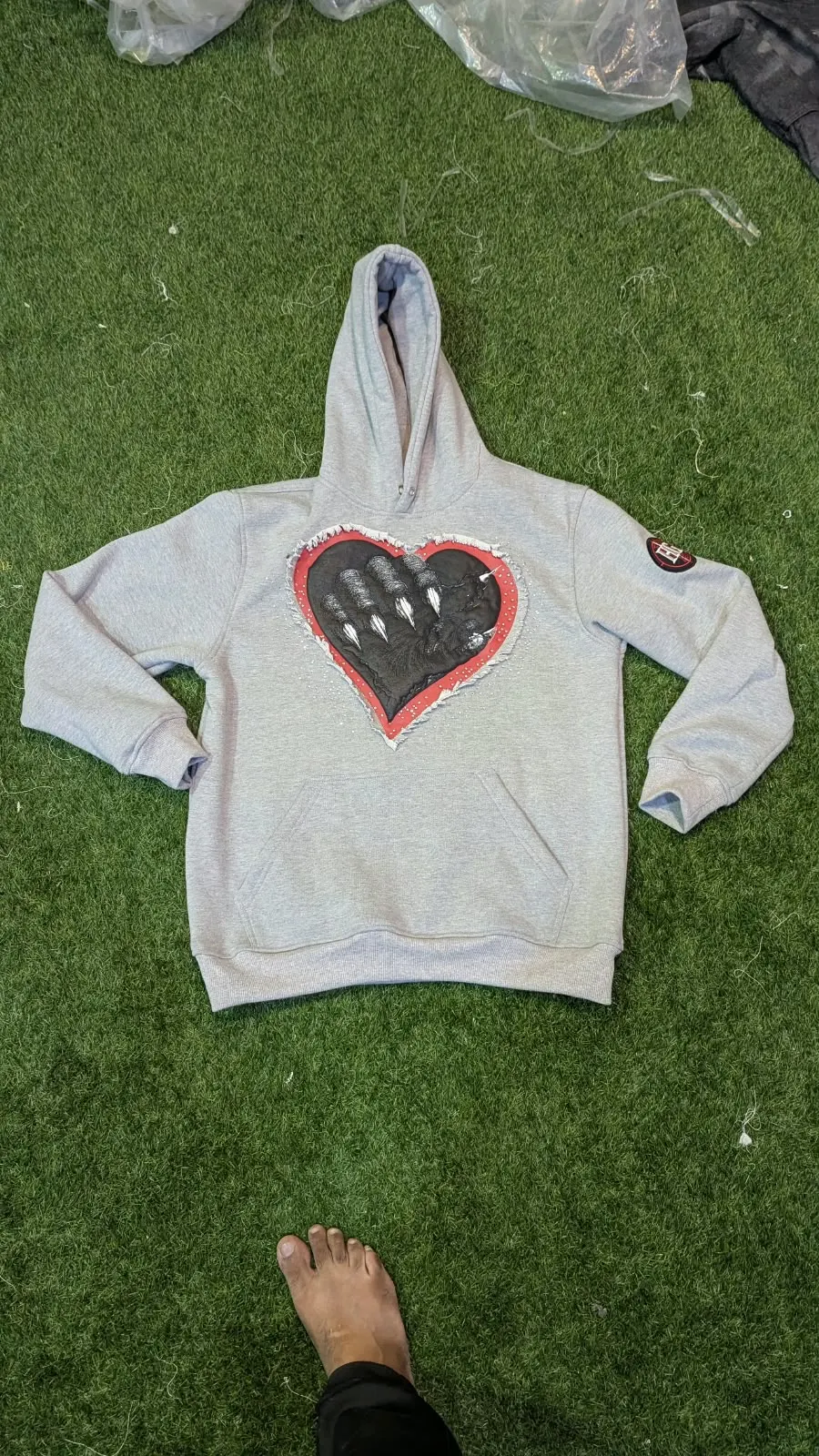 Custom grey hoodie with appliqué heart made by Ravix Pro Industry clothing manufacturer in Sialkot, Pakistan