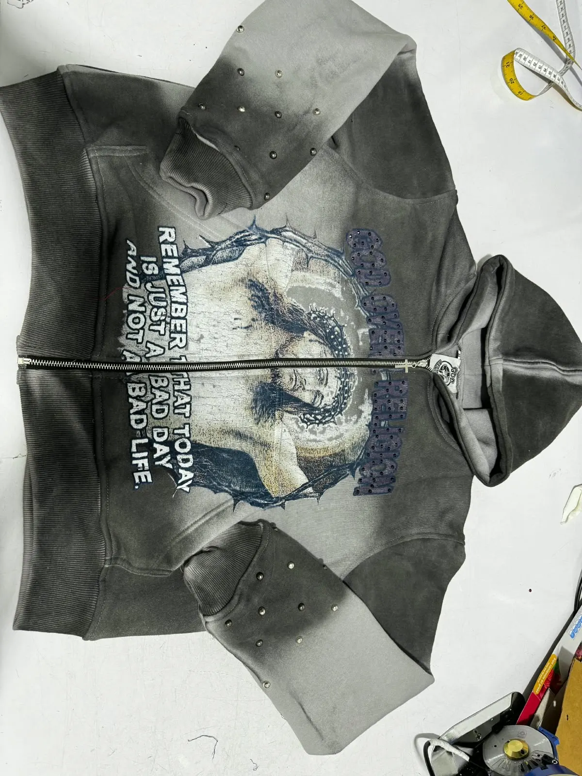 Custom acid wash hoodie with distressed print made by Ravix Pro Industry clothing manufacturer in Sialkot, Pakistan