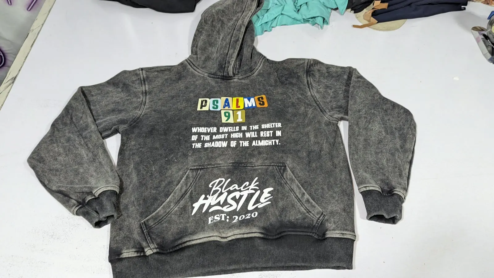 Custom acid wash hoodie with puff print made by Ravix Pro Industry clothing manufacturer in Sialkot, Pakistan