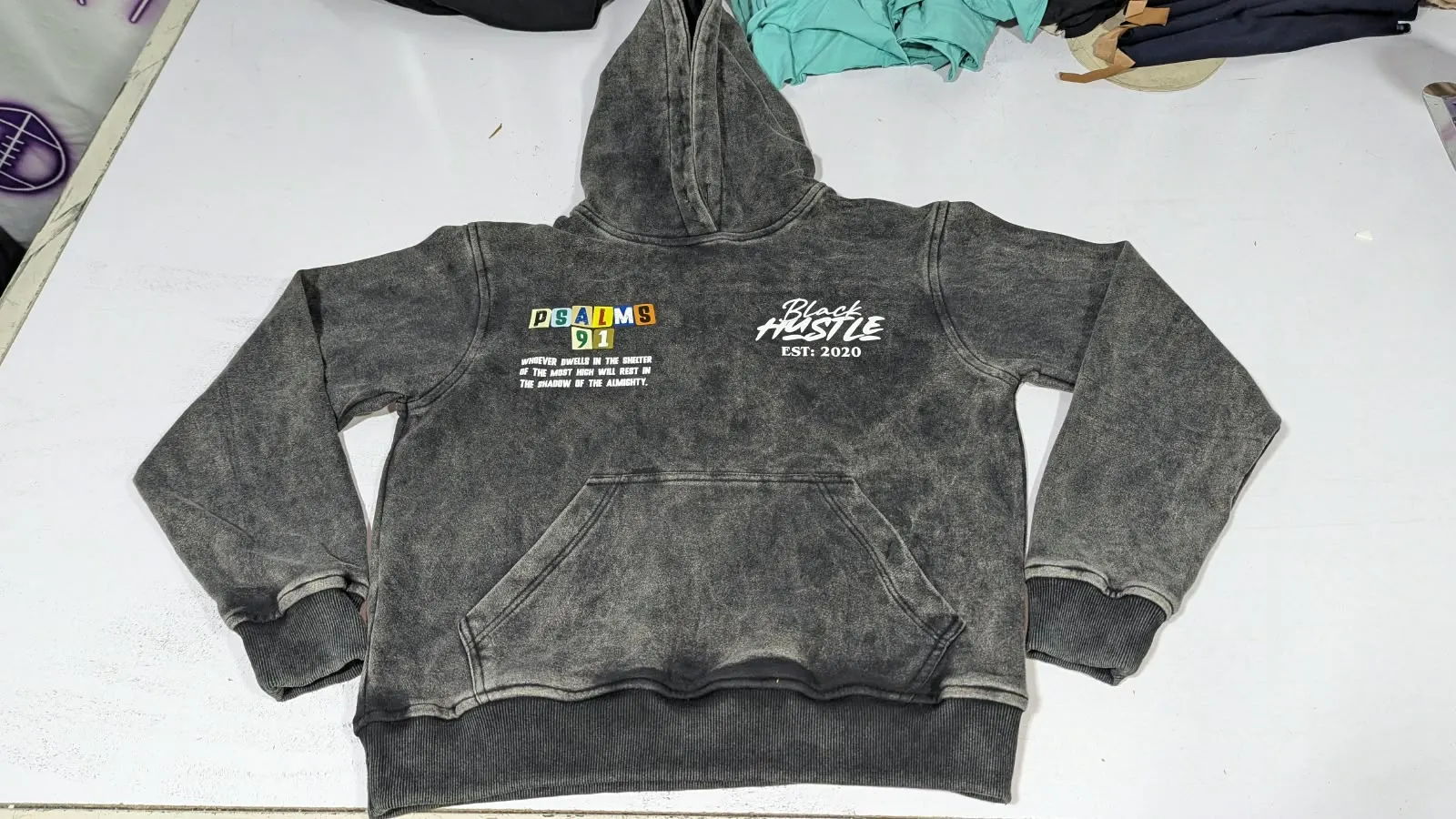 Custom acid wash hoodie with screen print made by Ravix Pro Industry clothing manufacturer in Sialkot, Pakistan