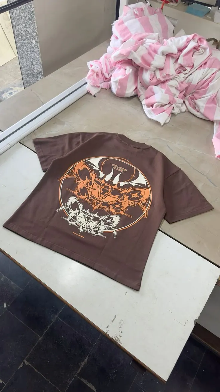 Custom brown streetwear T-shirt with graphic print made by Ravix Pro Industry clothing manufacturer in Sialkot, Pakistan