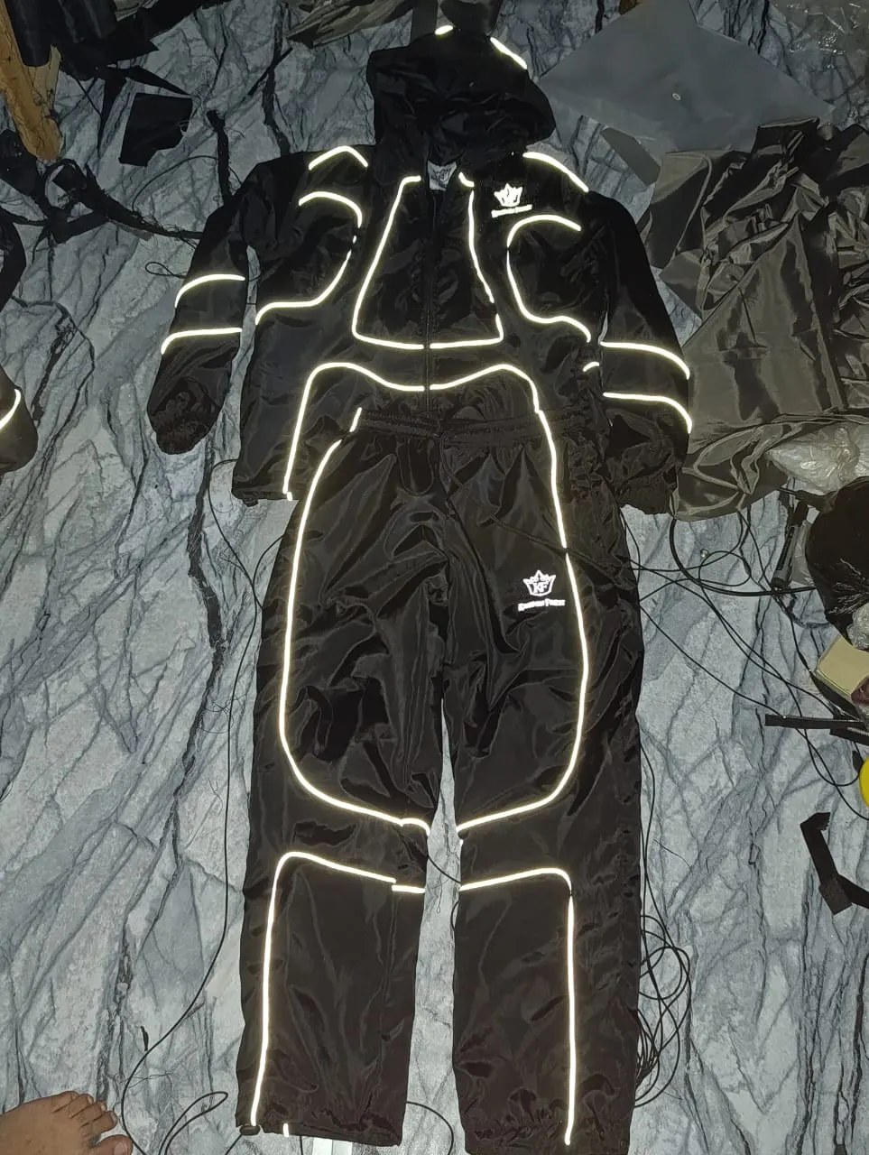 Custom black tracksuit with reflective outline print made by Ravix Pro Industry clothing manufacturer in Sialkot, Pakistan