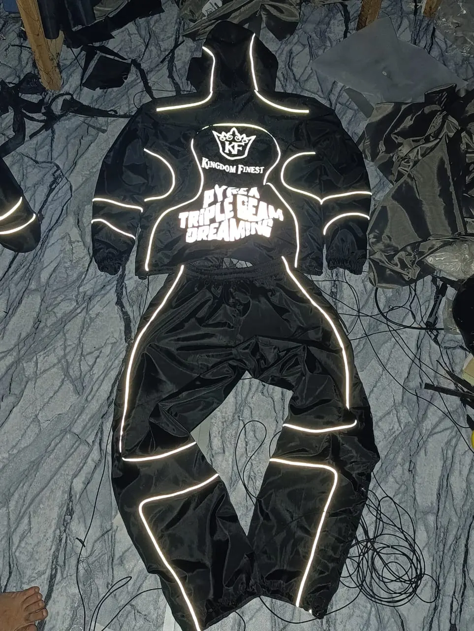 Custom black hoodie and pants set with reflective print made by Ravix Pro Industry clothing manufacturer in Sialkot, Pakistan