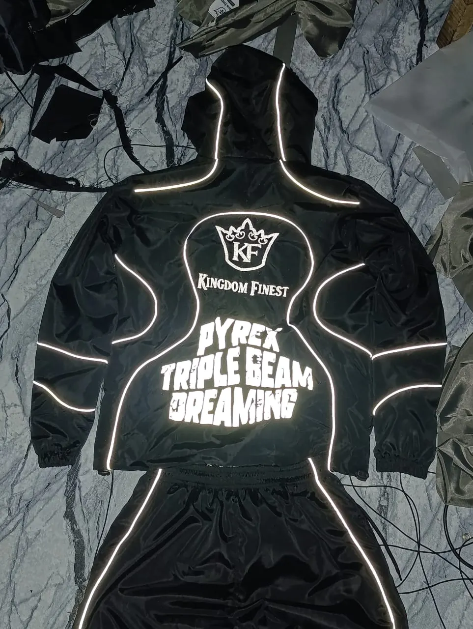 Custom black hoodie with reflective outline print made by Ravix Pro Industry clothing manufacturer in Sialkot, Pakistan