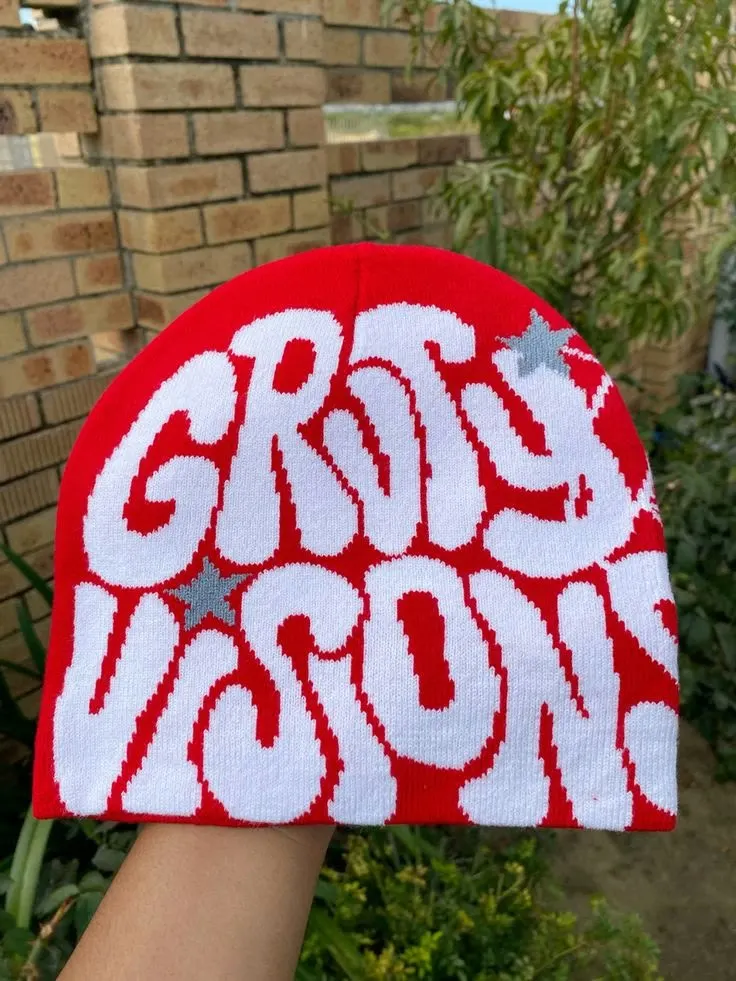 Custom red knitted beanie with jacquard lettering made by Ravix Pro Industry clothing manufacturer in Sialkot, Pakistan