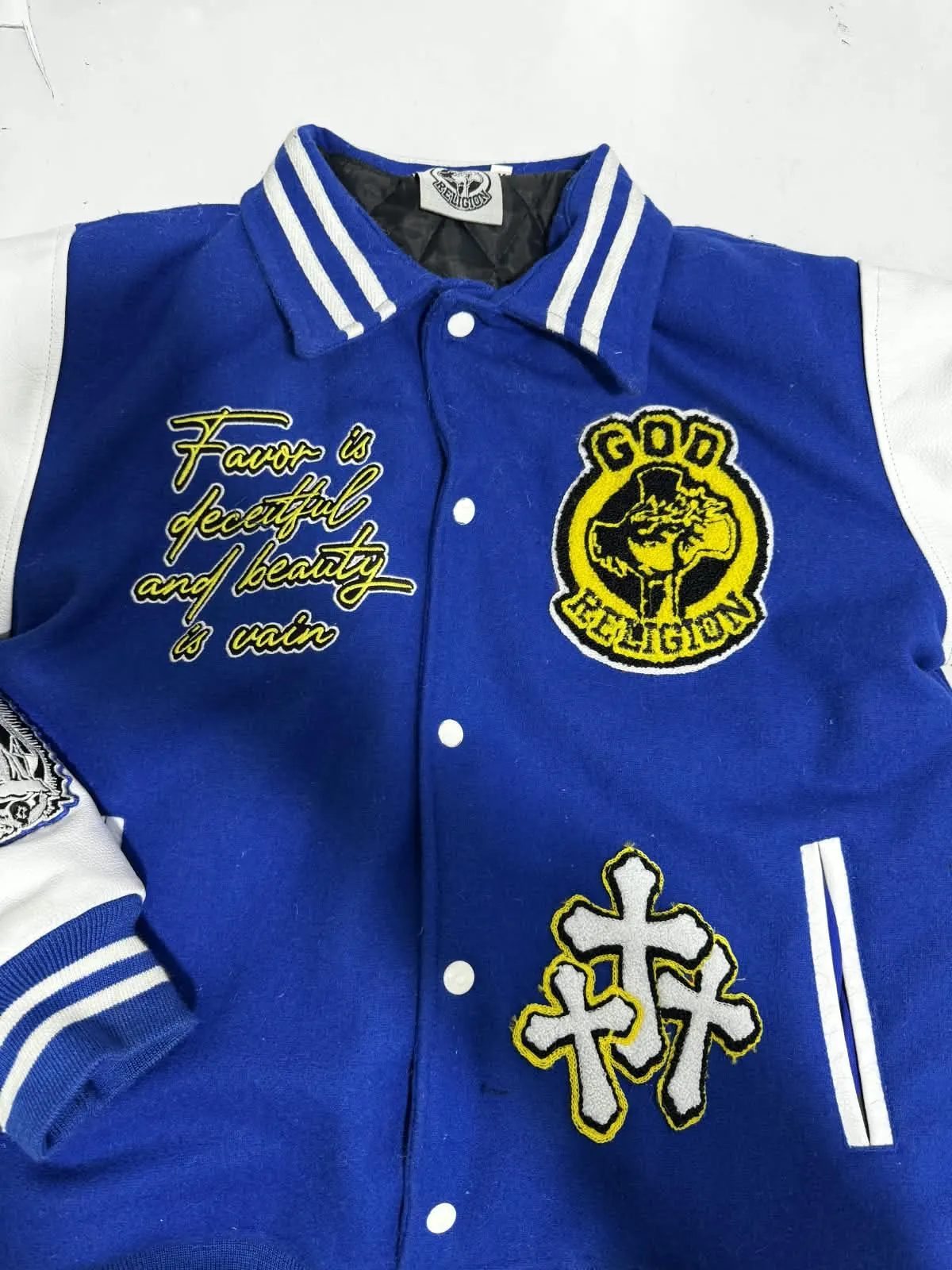 Custom royal blue varsity jacket with embroidered patches made by Ravix Pro Industry clothing manufacturer in Sialkot, Pakistan