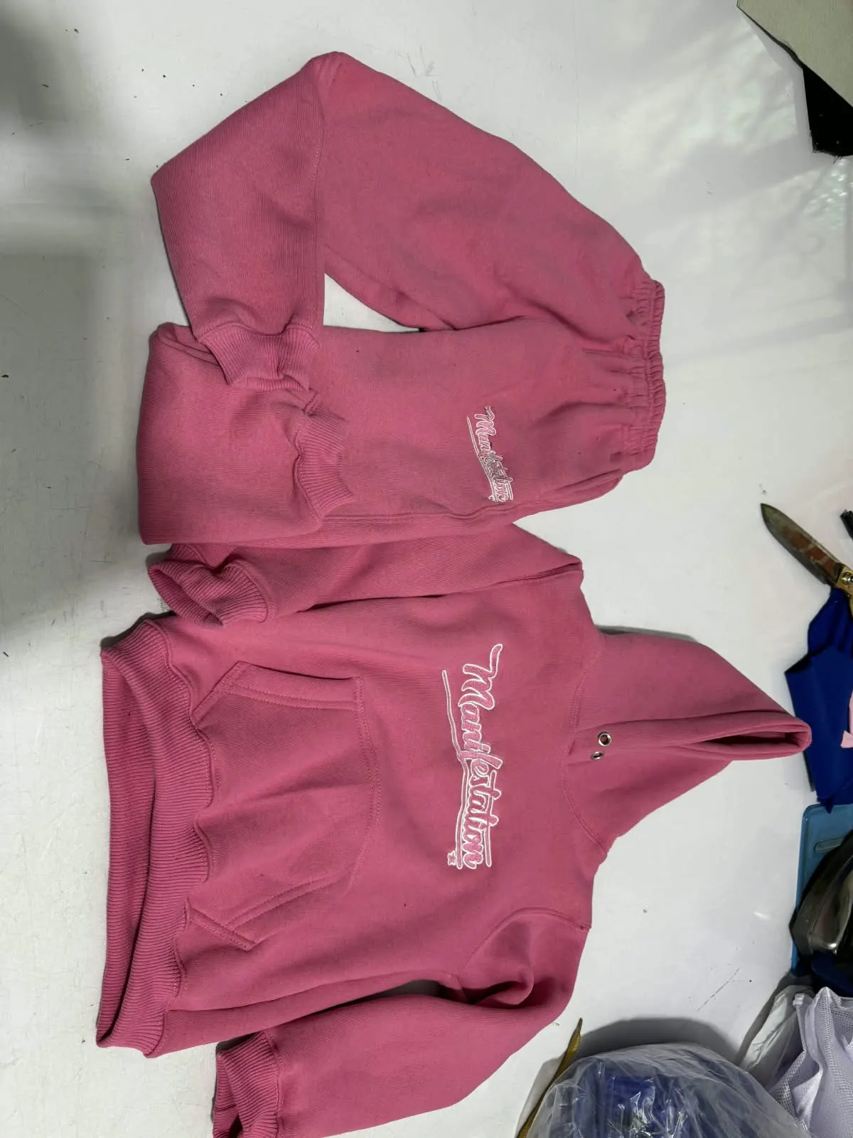 Custom pink hoodie with embroidered logo made by Ravix Pro Industry clothing manufacturer in Sialkot, Pakistan