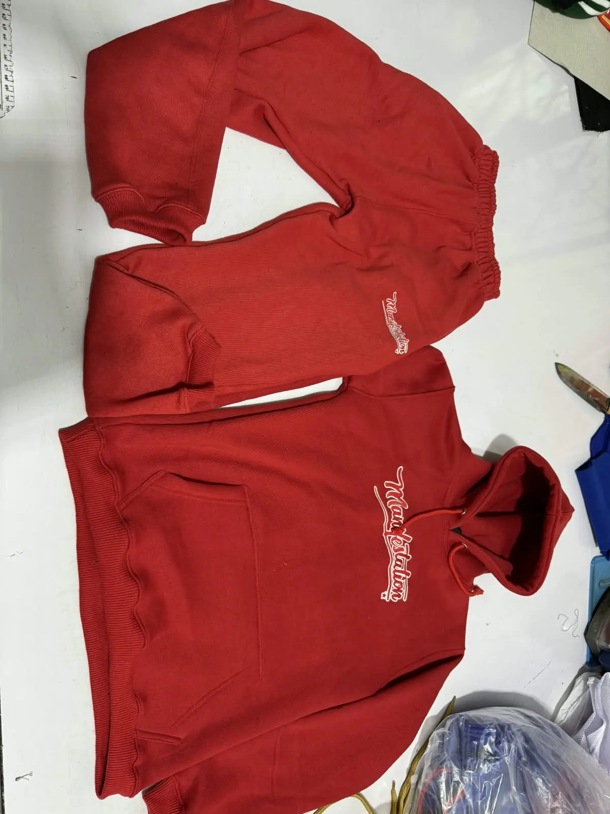 Custom red hoodie with embroidered logo made by Ravix Pro Industry clothing manufacturer in Sialkot, Pakistan