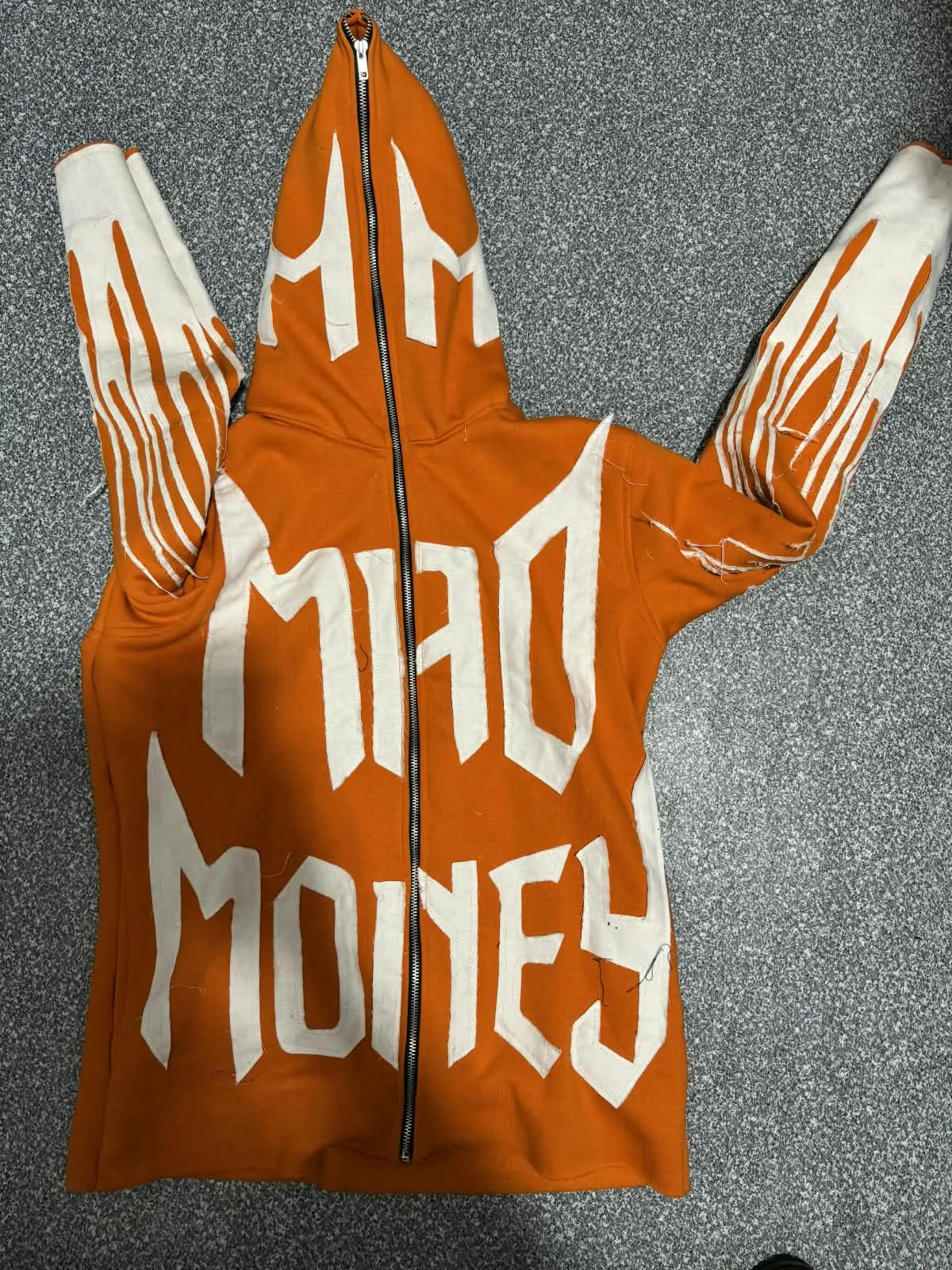 Custom orange full-zip hoodie with puff print lettering made by Ravix Pro Industry clothing manufacturer in Sialkot, Pakistan
