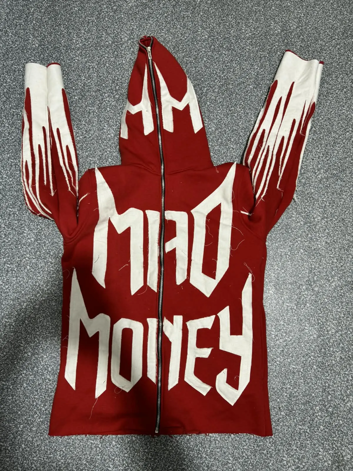 Custom red full-zip hoodie with puff print lettering made by Ravix Pro Industry clothing manufacturer in Sialkot, Pakistan
