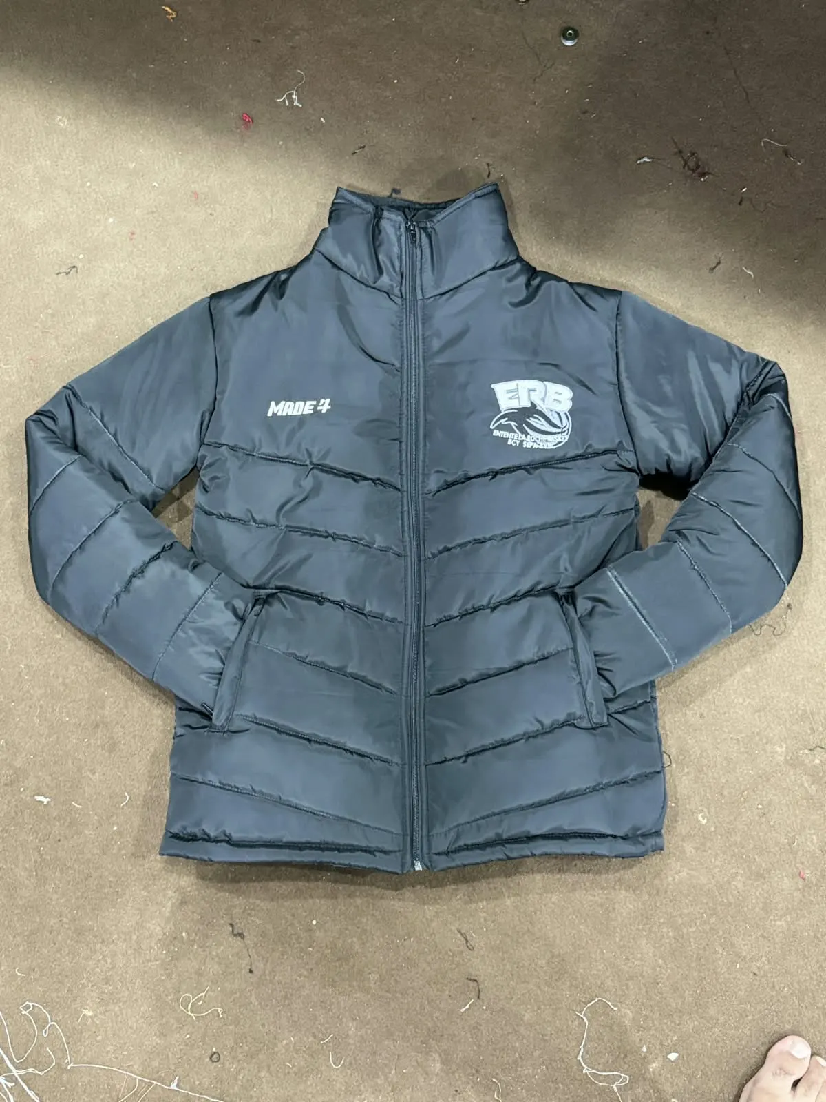 Custom blue puffer jacket with embroidered logo made by Ravix Pro Industry clothing manufacturer in Sialkot, Pakistan
