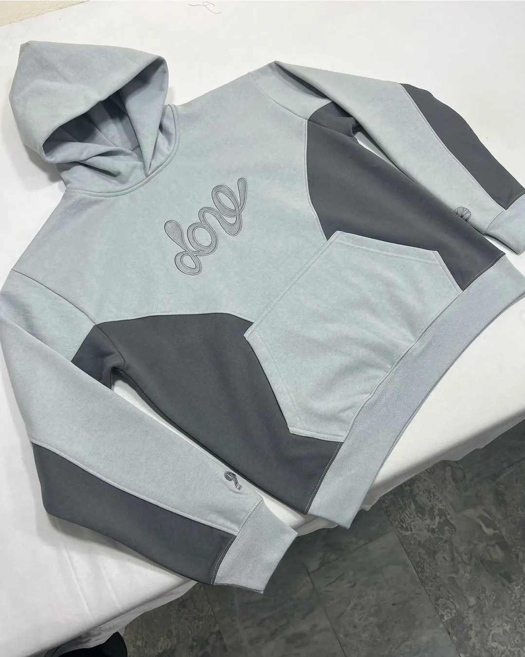 Custom grey colour-block hoodie made by Ravix Pro Industry clothing manufacturer in Sialkot, Pakistan