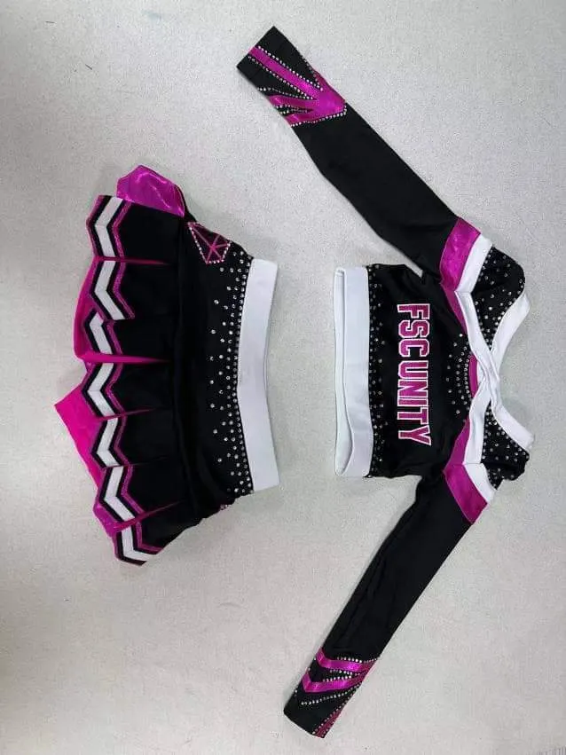 Custom cheerleading uniform in black and pink made by Ravix Pro Industry clothing manufacturer in Sialkot, Pakistan