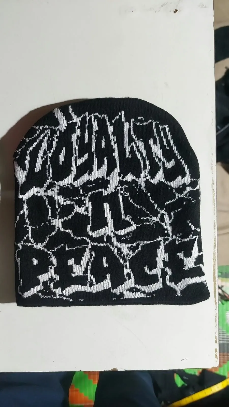 Custom black and white jacquard knitted beanie made by Ravix Pro Industry clothing manufacturer in Sialkot, Pakistan