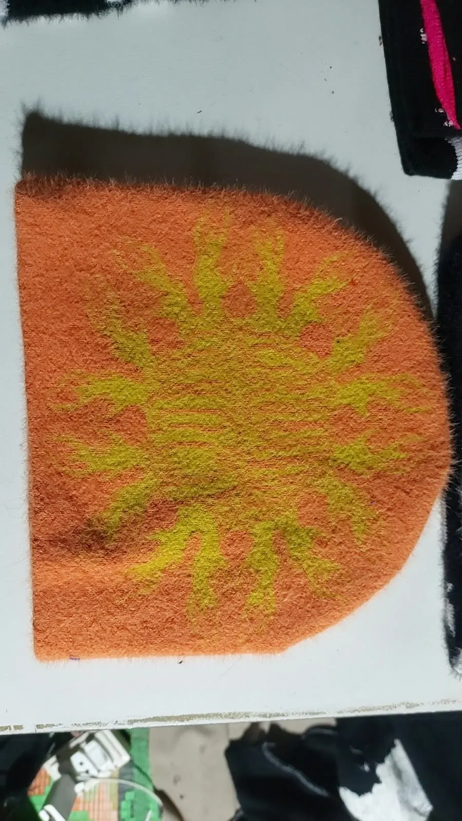 Custom orange mohair beanie with jacquard design made by Ravix Pro Industry clothing manufacturer in Sialkot, Pakistan