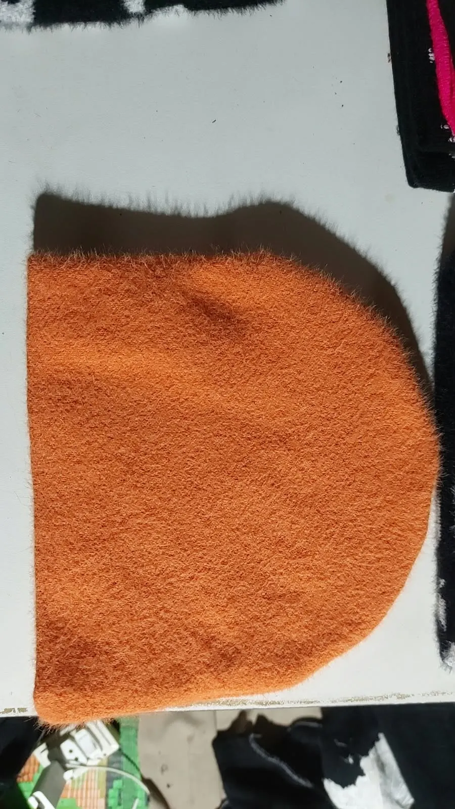 Custom orange mohair beanie made by Ravix Pro Industry clothing manufacturer in Sialkot, Pakistan