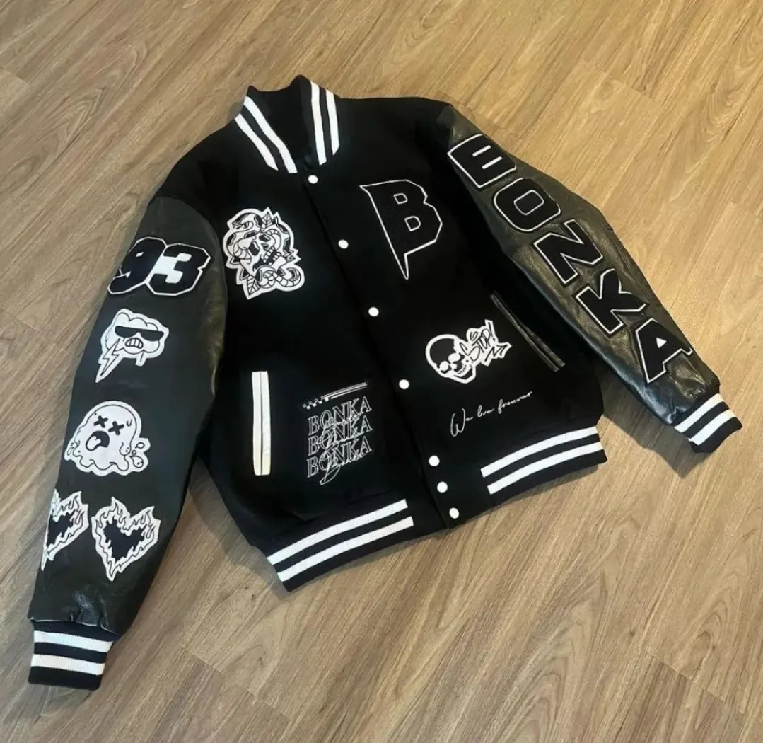 Custom black wool varsity jacket with patches made by Ravix Pro Industry clothing manufacturer in Sialkot, Pakistan