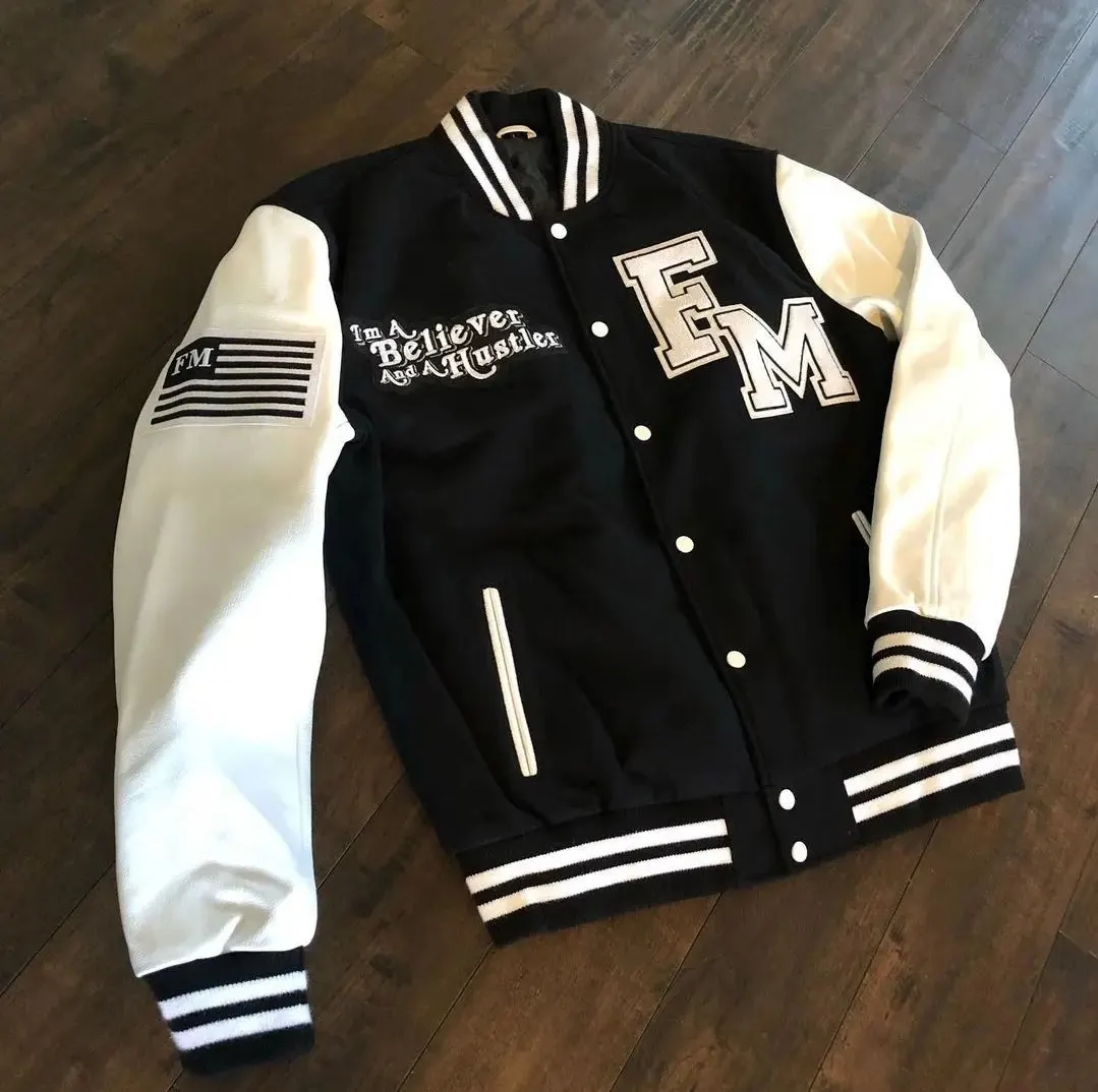 Custom black varsity jacket with white sleeves made by Ravix Pro Industry clothing manufacturer in Sialkot, Pakistan