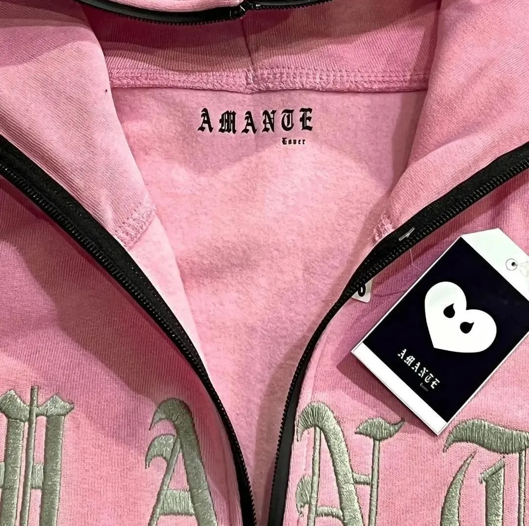 Custom pink zip hoodie lettering detail made by Ravix Pro Industry clothing manufacturer in Sialkot, Pakistan