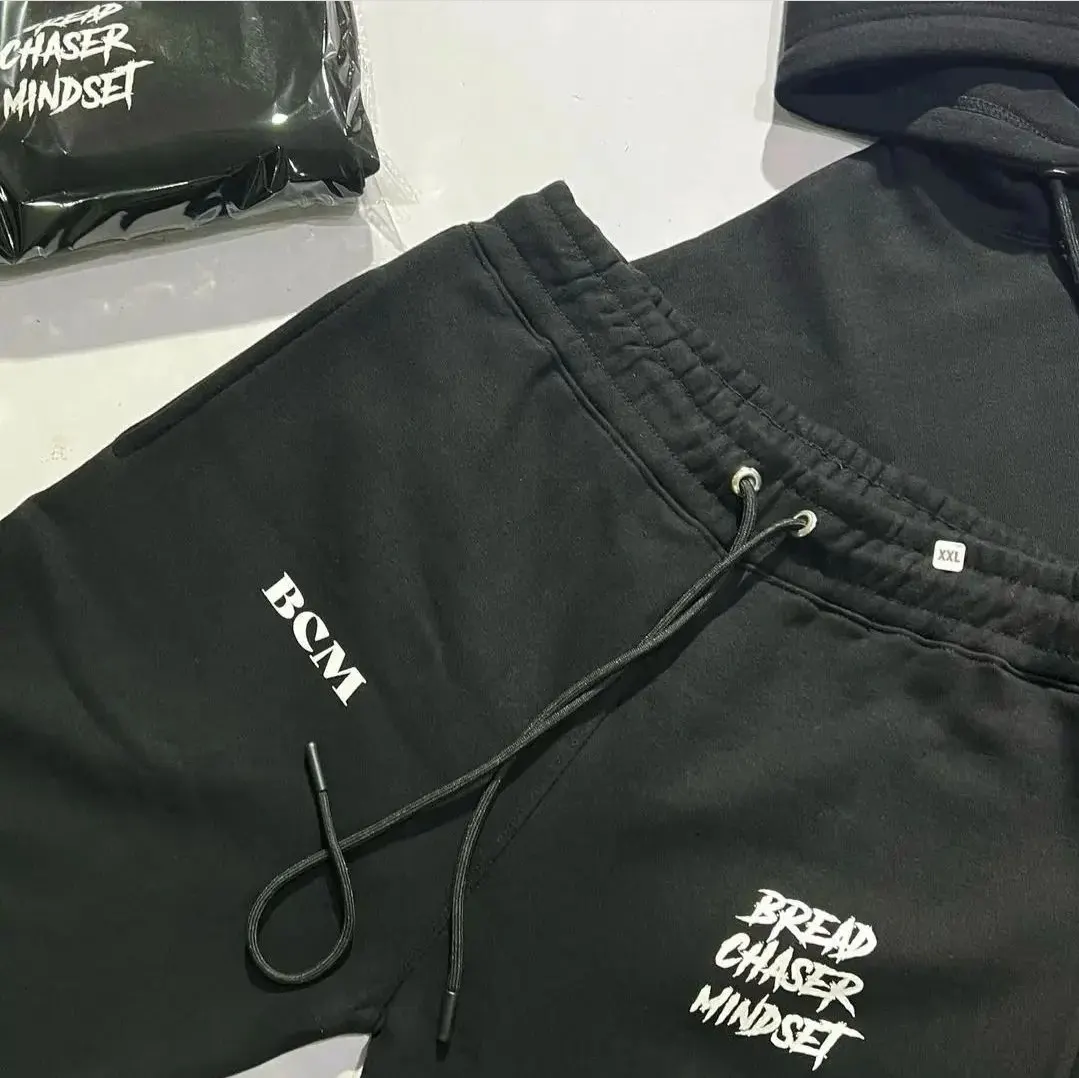 Custom black sweatpants with puff print made by Ravix Pro Industry clothing manufacturer in Sialkot, Pakistan