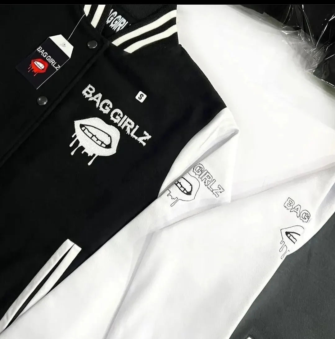 Custom black and white varsity jacket with embroidery made by Ravix Pro Industry clothing manufacturer in Sialkot, Pakistan