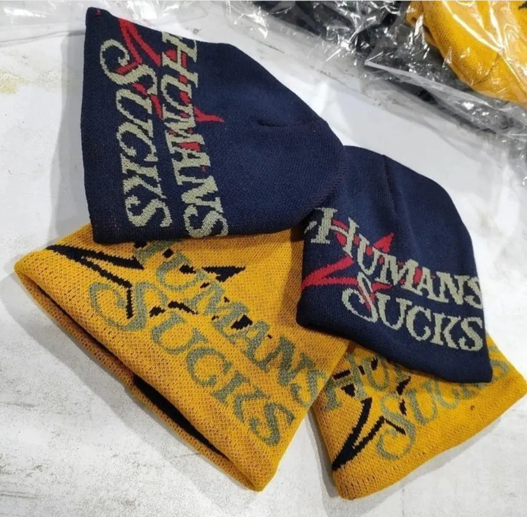 Custom jacquard knitted beanies in navy and gold made by Ravix Pro Industry clothing manufacturer in Sialkot, Pakistan