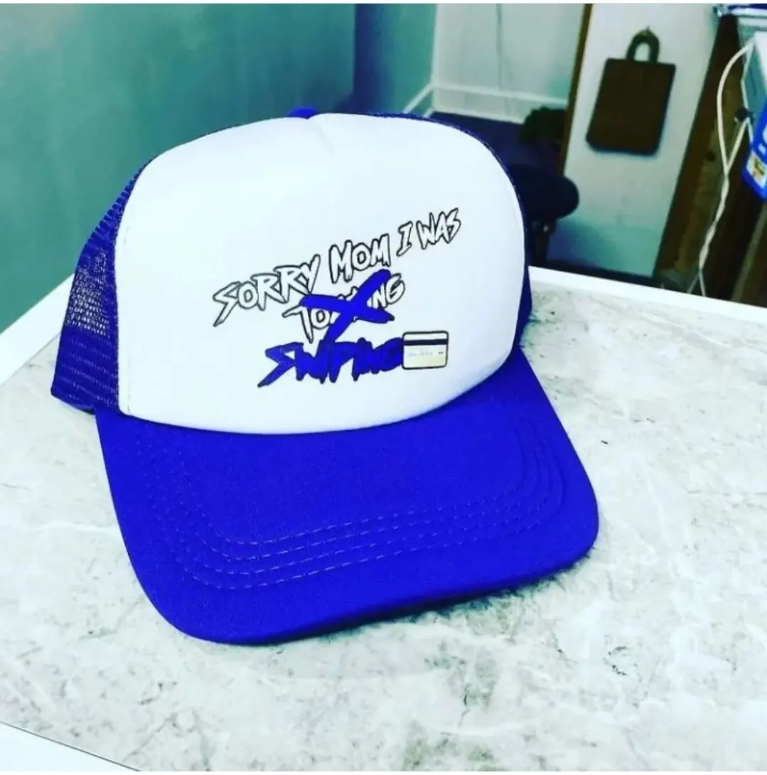 Custom blue and white trucker cap with print made by Ravix Pro Industry clothing manufacturer in Sialkot, Pakistan