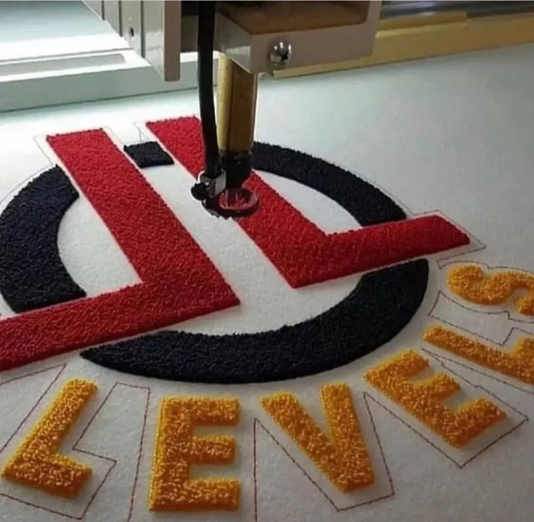 Custom chenille patch with embroidered border made by Ravix Pro Industry clothing manufacturer in Sialkot, Pakistan