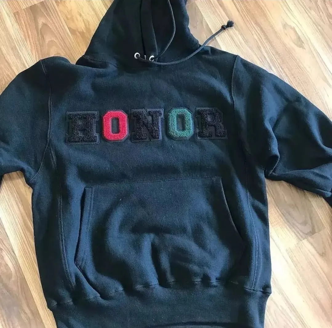 Custom black hoodie with embroidered lettering made by Ravix Pro Industry clothing manufacturer in Sialkot, Pakistan